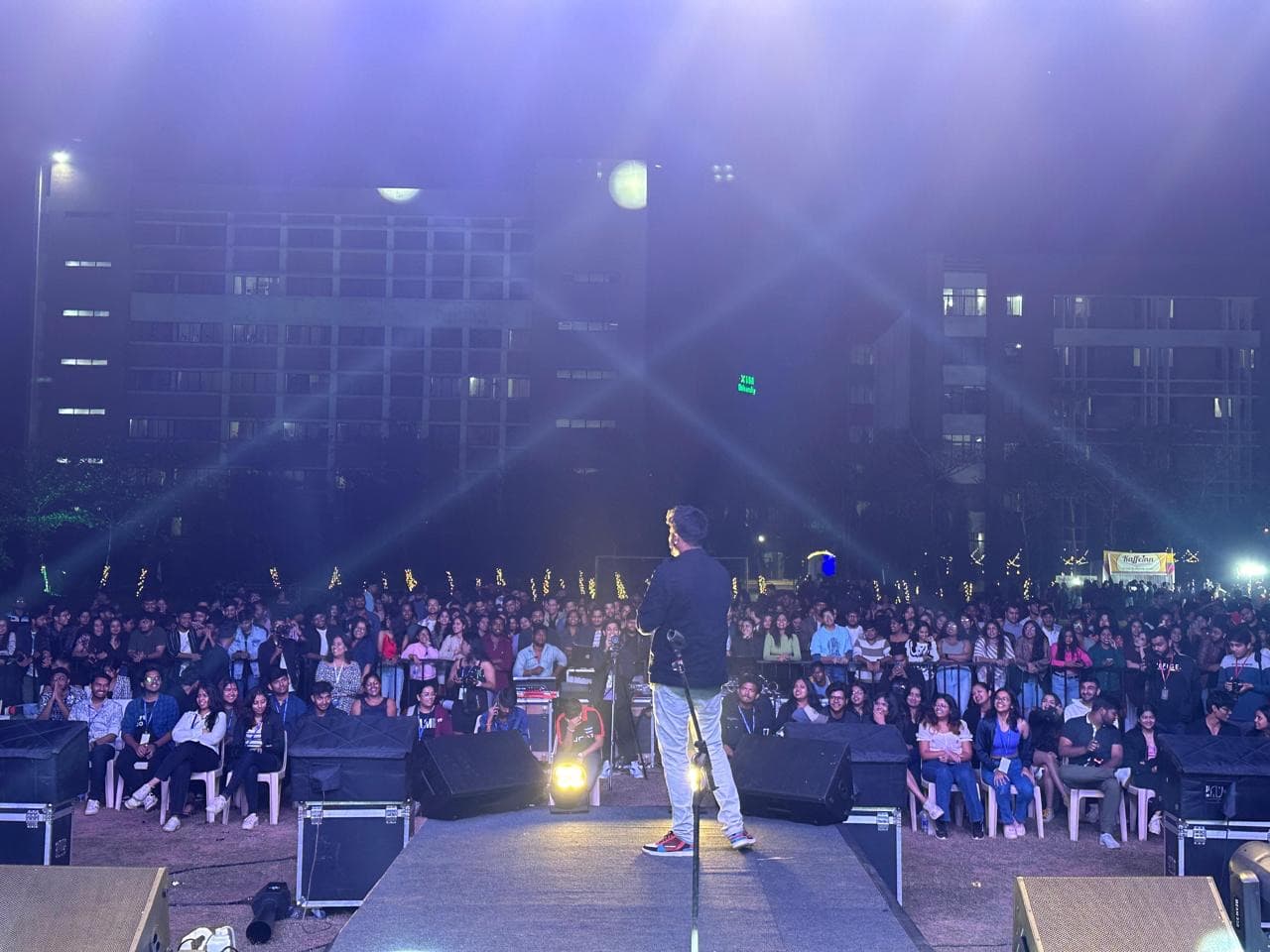 A zerith teammate on stage in front of a packed crowd