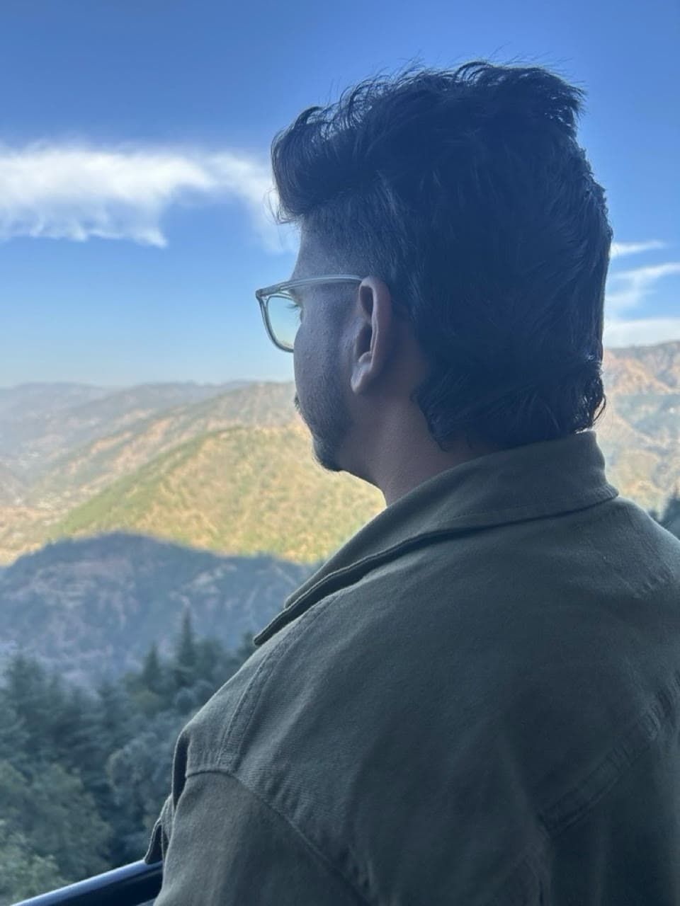 A zerith teammate looking out over a mountain valley